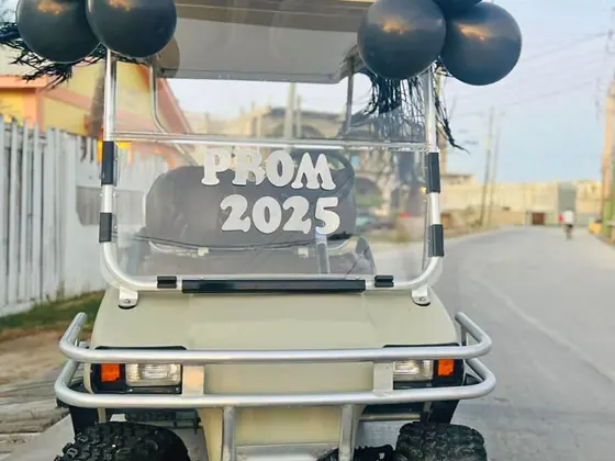 Visitors driving a rental golf cart on Ambergris Caye