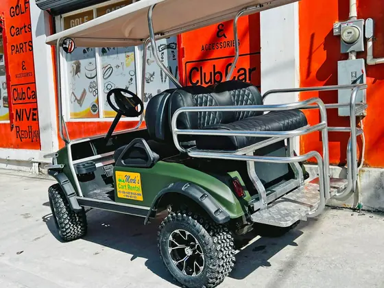 Golf cart rental parked outside a resort in San Pedro