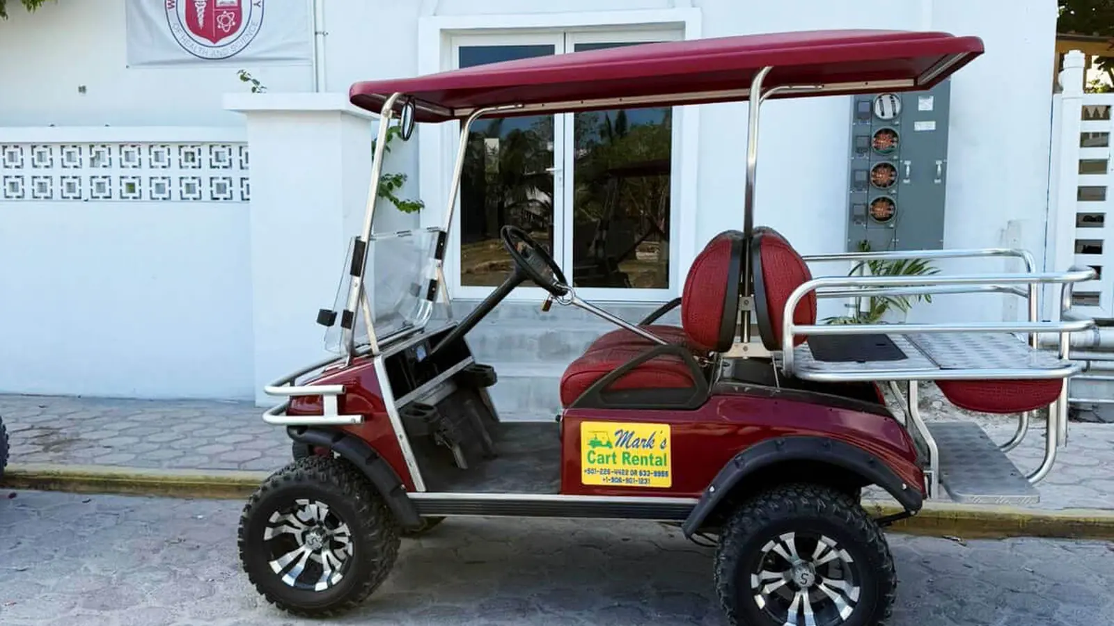 Six seater gas golf cart on the coastal road in Ambergris Caye Belize